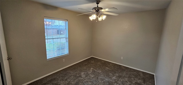 carpeted spare room featuring ceiling fan