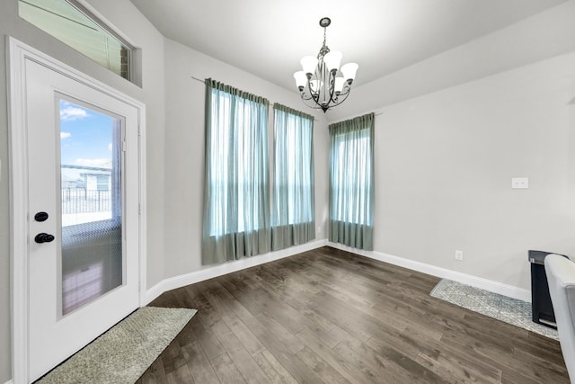 interior space featuring dark hardwood / wood-style floors and a chandelier