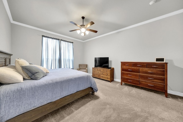 carpeted bedroom with crown molding and ceiling fan