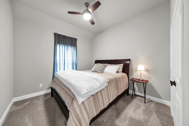 bedroom with ceiling fan and dark colored carpet