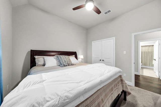 bedroom with a closet, vaulted ceiling, ceiling fan, and dark hardwood / wood-style flooring