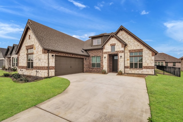 view of front of property with a front yard and a garage