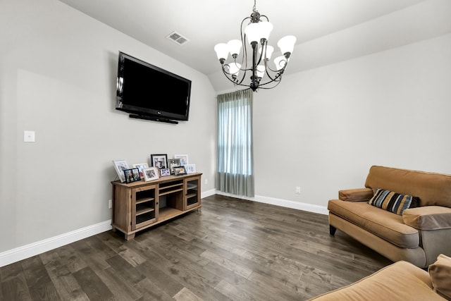 living area featuring dark hardwood / wood-style floors and a notable chandelier