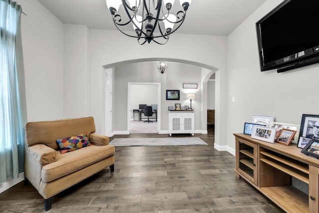 sitting room featuring dark hardwood / wood-style flooring and a chandelier