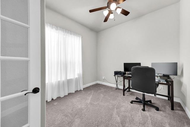 carpeted office with ceiling fan and a healthy amount of sunlight