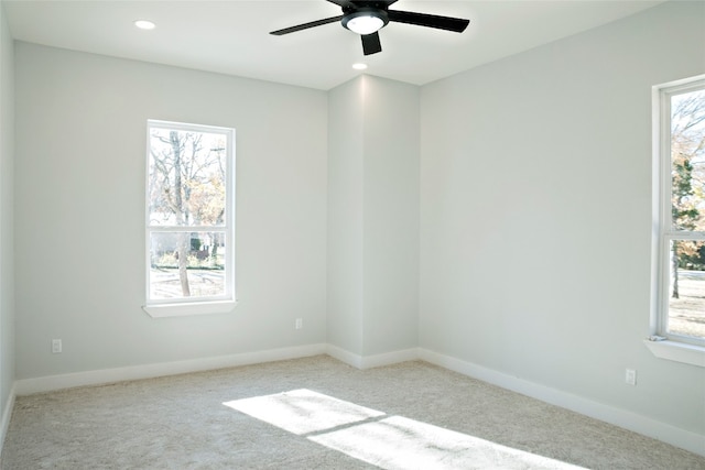 empty room featuring light carpet and ceiling fan