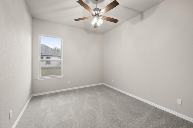 spare room featuring ceiling fan and carpet flooring