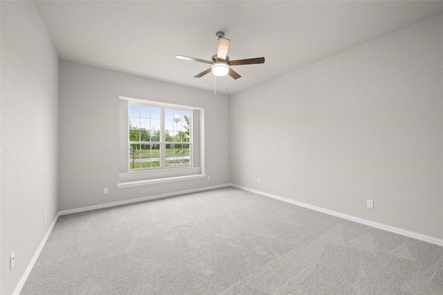 unfurnished room featuring ceiling fan and carpet