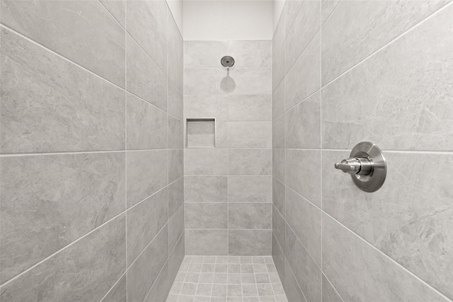 bathroom with a tile shower