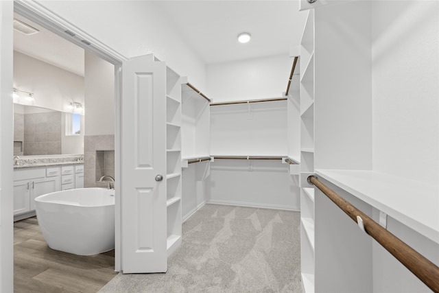 walk in closet featuring light hardwood / wood-style floors