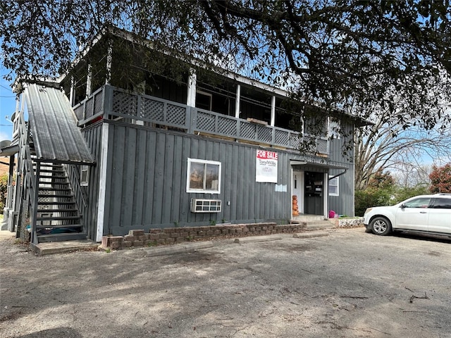 view of side of property with a balcony