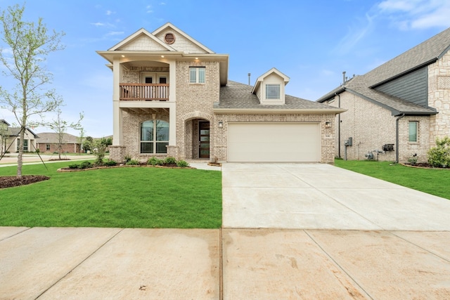 view of front of home featuring a garage, a balcony, and a front yard