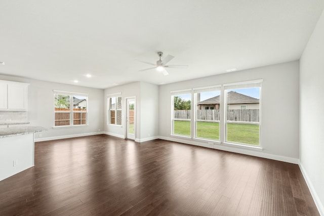 unfurnished bedroom featuring dark carpet, ceiling fan, and vaulted ceiling