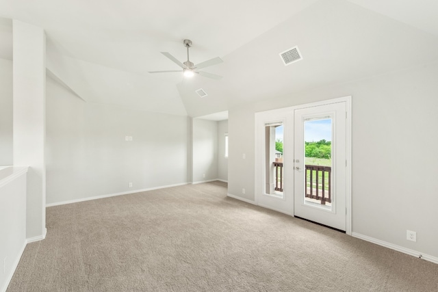 carpeted empty room featuring ceiling fan and vaulted ceiling