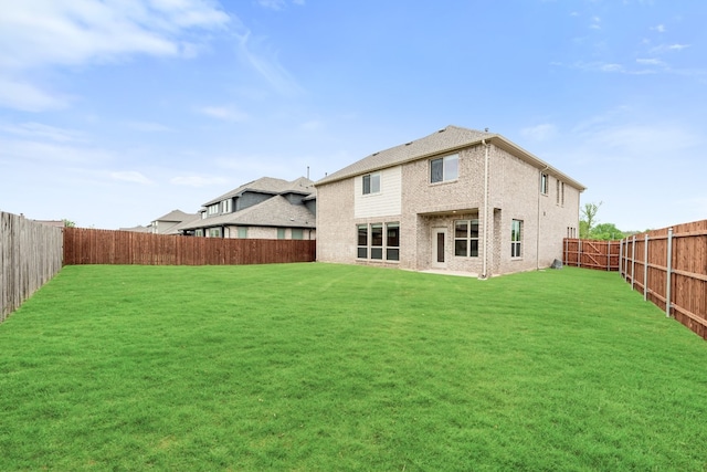 back of house with a yard