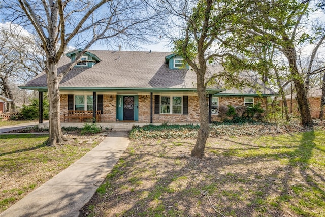 view of front of house with a porch and a front lawn