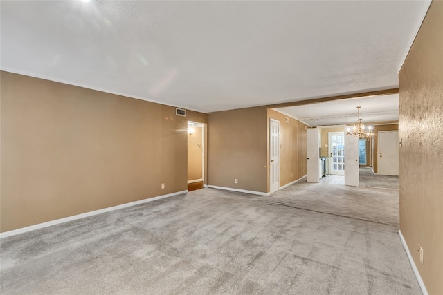 unfurnished room with light carpet, a chandelier, and crown molding