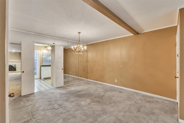 unfurnished room featuring light carpet, beam ceiling, a textured ceiling, and a chandelier