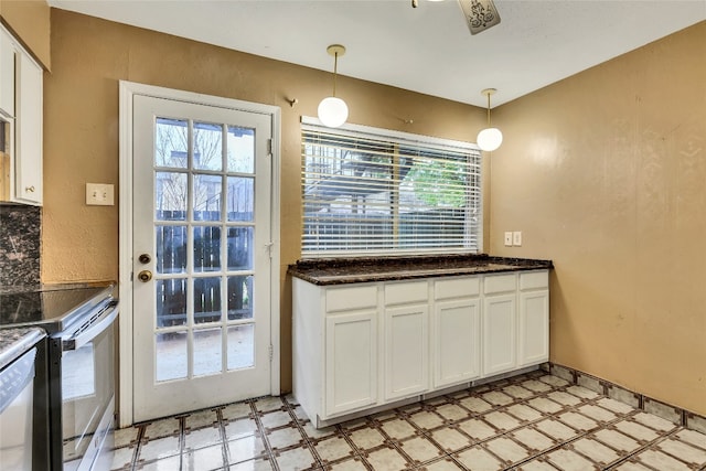 kitchen with white cabinets, plenty of natural light, light tile floors, and decorative light fixtures