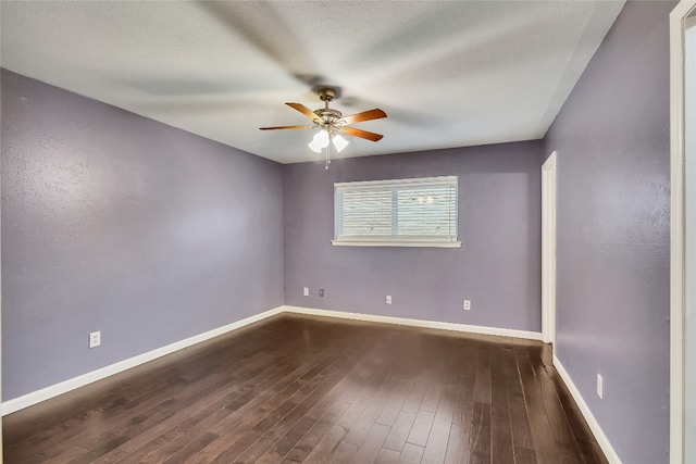 empty room with dark wood-type flooring, a textured ceiling, and ceiling fan