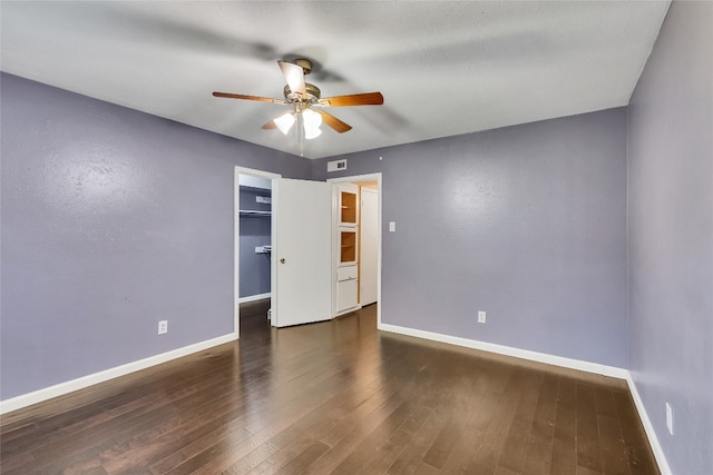 unfurnished bedroom with a closet, dark hardwood / wood-style floors, and ceiling fan