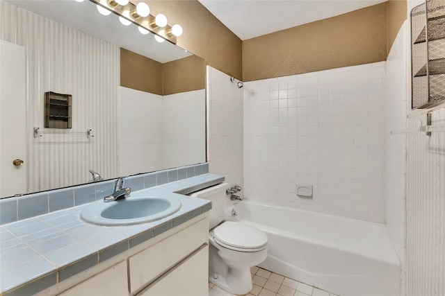 full bathroom with tiled shower / bath combo, oversized vanity, toilet, and tile flooring