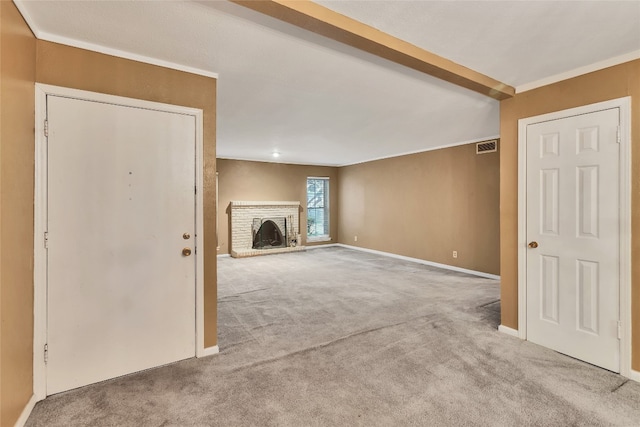 unfurnished living room featuring light carpet, crown molding, and a fireplace