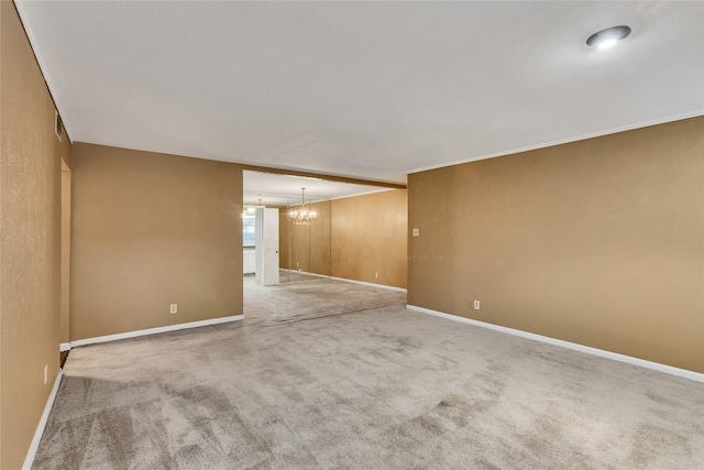 unfurnished room with light carpet and an inviting chandelier