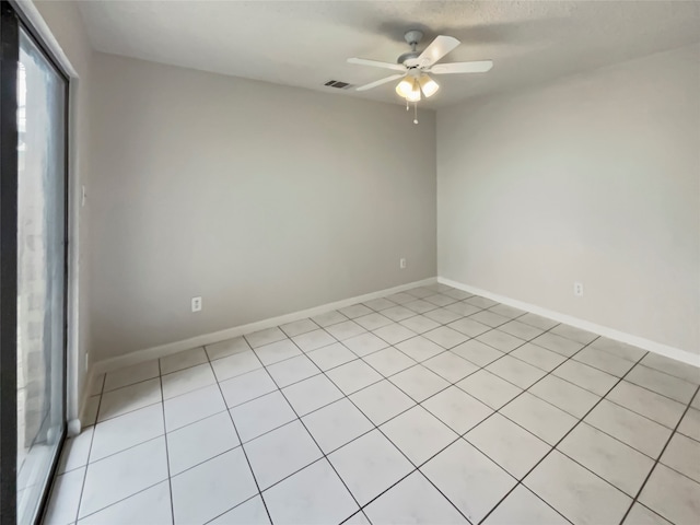 tiled empty room with ceiling fan