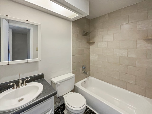 full bathroom featuring toilet, vanity, and tiled shower / bath