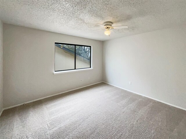 carpeted empty room featuring a textured ceiling and ceiling fan