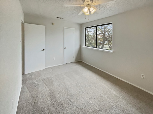 unfurnished bedroom with a closet, carpet floors, a textured ceiling, and ceiling fan