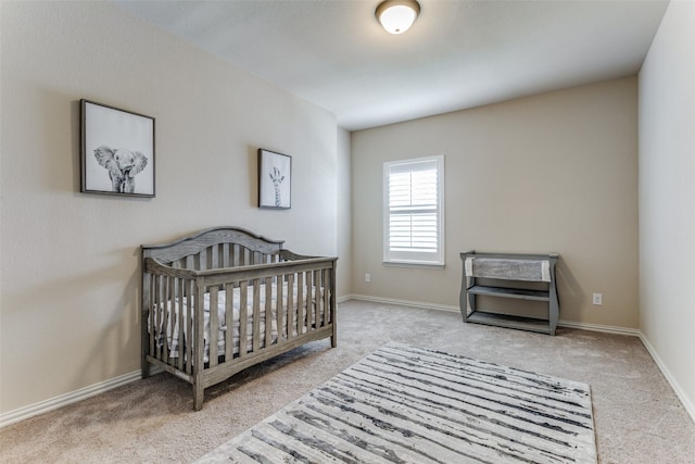 carpeted bedroom featuring a crib