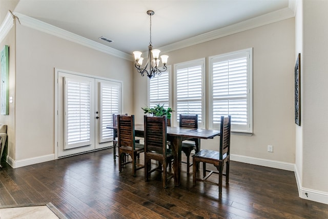 dining room featuring a notable chandelier, dark hardwood / wood-style floors, and ornamental molding