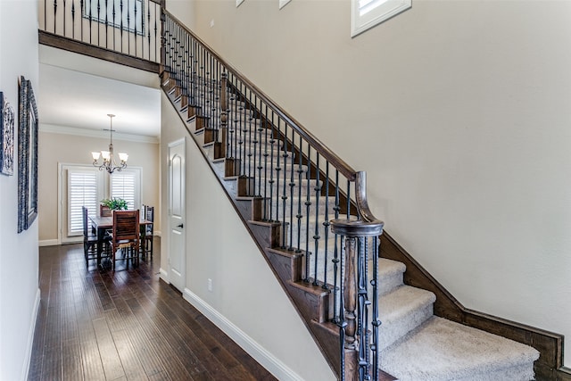 dining room featuring dark hardwood / wood-style floors, a chandelier, and crown molding