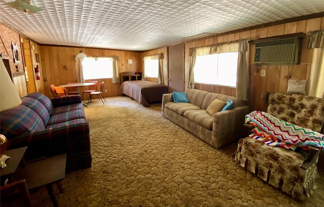 carpeted living room featuring wooden walls and a wall unit AC