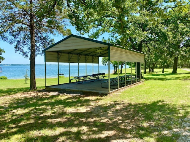 view of home's community with a lawn and a water view