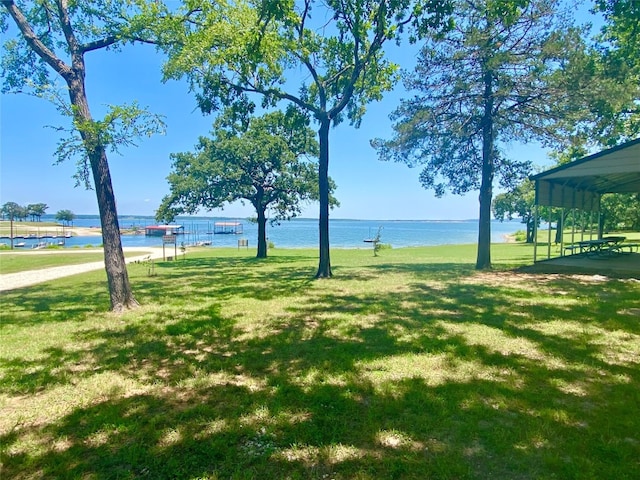 view of home's community featuring a water view and a yard