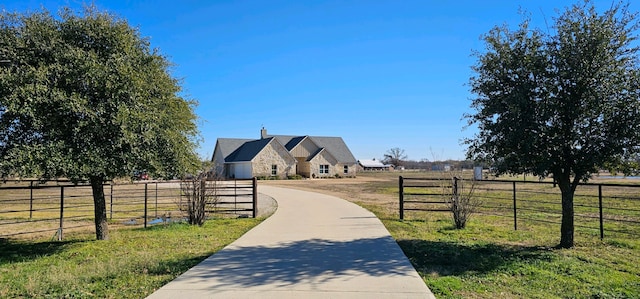 view of community with a yard and a rural view