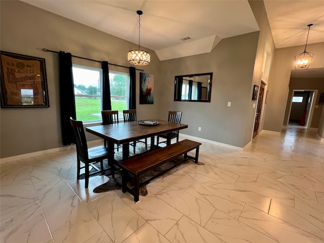 dining space featuring vaulted ceiling and a notable chandelier