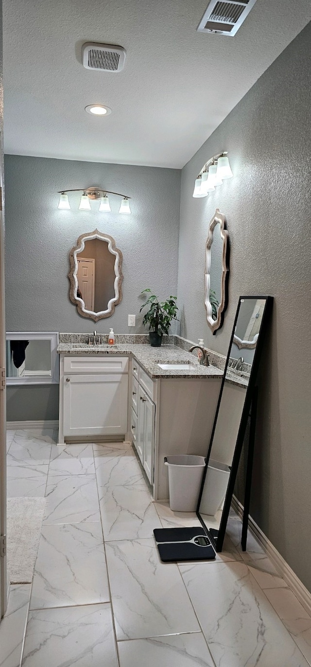 bathroom featuring vanity and a textured ceiling