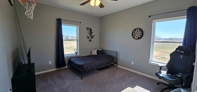 carpeted bedroom with multiple windows and ceiling fan