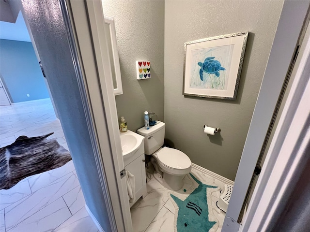 bathroom featuring toilet and vanity