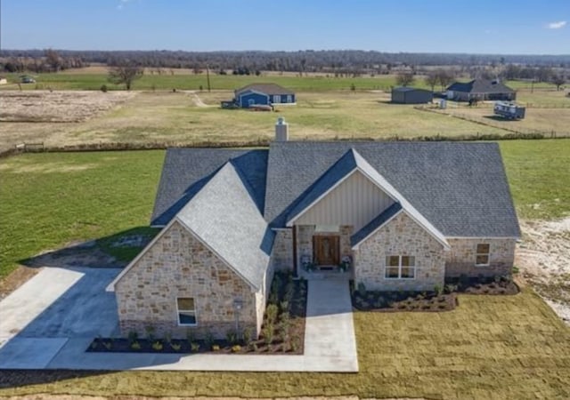 birds eye view of property with a rural view