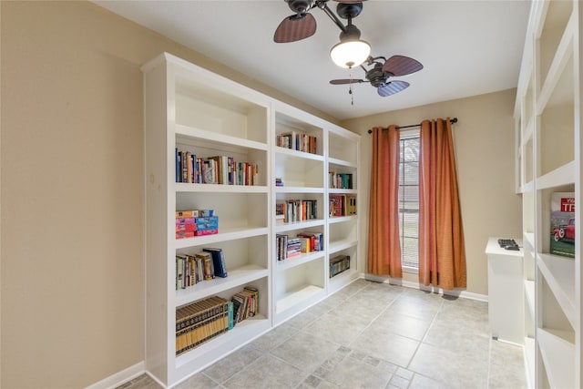 unfurnished room featuring ceiling fan, built in features, and light tile floors