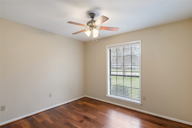 empty room featuring ceiling fan and dark hardwood / wood-style floors