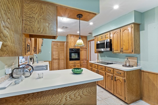 kitchen featuring kitchen peninsula, black appliances, sink, light tile floors, and pendant lighting