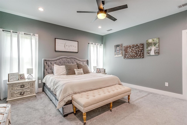 bedroom featuring light colored carpet and ceiling fan