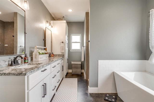 bathroom with concrete flooring and dual bowl vanity