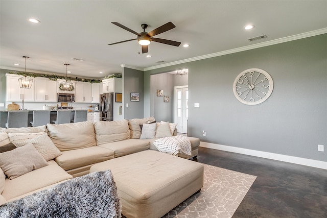 living room featuring crown molding, ceiling fan, and a large fireplace